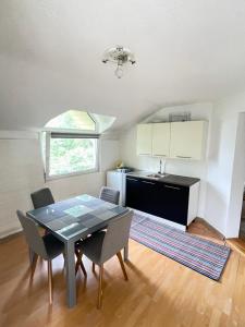 a kitchen and dining room with a table and chairs at Neretva View in Počitelj