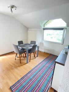 a dining room with a table and chairs and a window at Neretva View in Počitelj