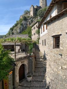 a group of stone buildings with a mountain in the background at Neretva View in Počitelj