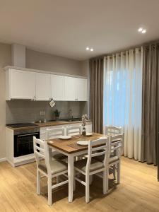 a kitchen with a table and chairs in a kitchen at Costa Adriatica Apartments in Durrës