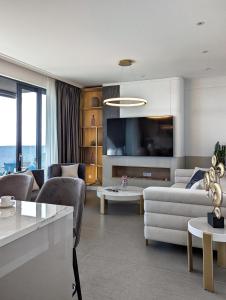 a living room with a couch and a tv at Beyond Breathtaking Modern Residence Sir. Perfect in Dubrovnik
