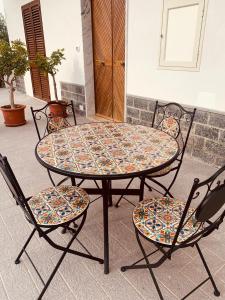 a table and two chairs and a table and chairs at Casa Vacanza Elena in Capo dʼOrlando