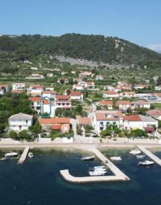 a small town with boats in the water at Holiday house Domy Rab in Barbat na Rabu