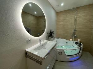 a bathroom with a sink and a mirror at Nice Renting - Love Room Massena - Luxe Room - Jacuzzi - Terrace - King Bed - AC in Nice