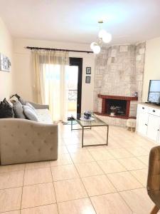 a living room with a couch and a fireplace at Nice apartment with amazing views in Kriopigi