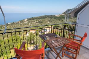 a table and chairs on a balcony with a view at Elena Studios in Athani