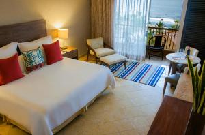 a hotel room with two beds and a television at Grand Fiesta Americana Los Cabos All Inclusive Golf & Spa in Cabo San Lucas