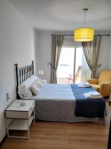 Postel nebo postele na pokoji v ubytování APARTAMENTO VILLA 3