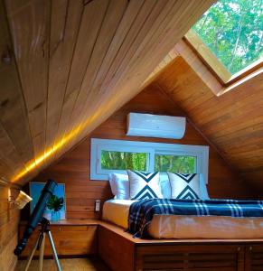 a bedroom with a bed in a wooden cabin at Vila Nambu - Exclusive Pousada in Gramado