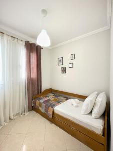 a bedroom with a bed and a window at URBAN APARTMENT in Lefkada Town