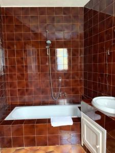 a bathroom with a bath tub and a sink at Casa Le Cicale in Porto Istana
