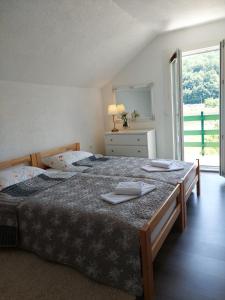 a bedroom with a large bed with two towels on it at La Reina Una in Bihać