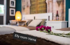 two purple flowers sitting on top of a couch at Bohemian Elly room Varna in Varna City