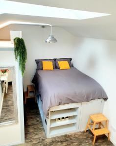 a bedroom with a bed with yellow pillows at West Park Annex - Central Wolverhampton in Wolverhampton