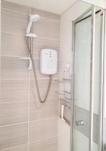 a shower with a shower head in a bathroom at West Park Annex - Central Wolverhampton in Wolverhampton +47 photos