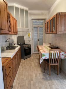 a kitchen with a stove and a table in it at Lovely apartment in the heart of Tangier in Tangier
