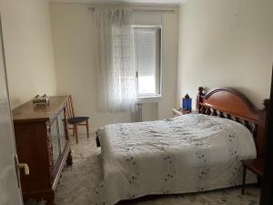 a bedroom with a bed and a dresser and a window at Lovely apartment in the heart of Tangier in Tangier