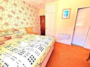 a bedroom with a bed with a floral wallpaper at The Albany hotel in Blackpool