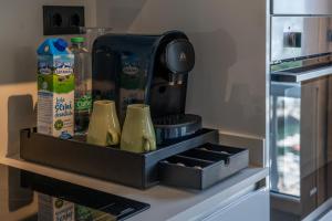a drawer in a refrigerator with a coffee maker at Apartamentos Mar y Sol in Luarca