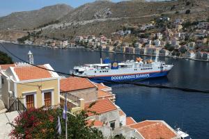 a boat is docked in a body of water at Little Symi House in Symi