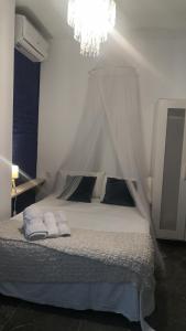 a bedroom with a white bed with a canopy at Cozy Rooms - BAÑERA HIDROMASAJE in Valencia