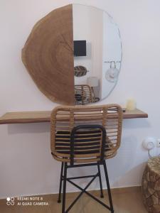 a wicker chair sitting on a shelf with a mirror at Mantelena studios & family apartments in Pollonia