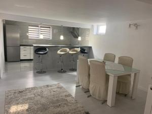 a kitchen with a table and chairs in a room at Casa Deac in Sebeş