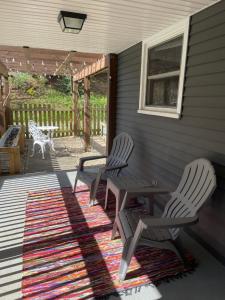 a patio with two chairs and a table on a rug at The Hideaway in Downtown Brevard in Brevard +23 photos