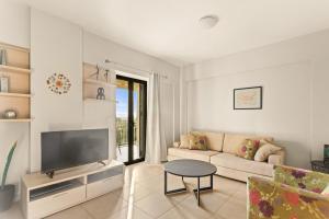 a living room with a couch and a tv at Nora's Villa in Riglia