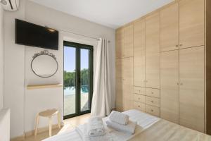 a bedroom with a bed and a large window at Nora's Villa in Riglia +26 photos