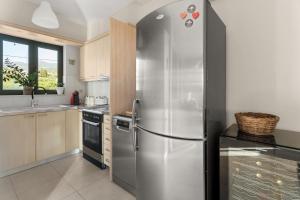 a kitchen with a stainless steel refrigerator at Nora's Villa in Riglia