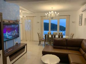 a living room with a couch and a dining room at Vila Wolf Montenegro in Budva