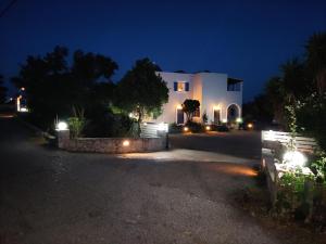 a house at night with lights in front of it at Vretti's apartment in Kythira