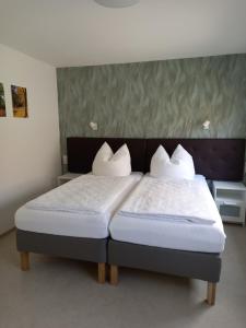 a bedroom with a bed with two pillows on it at Gästewohnung Meyer in Seehausen