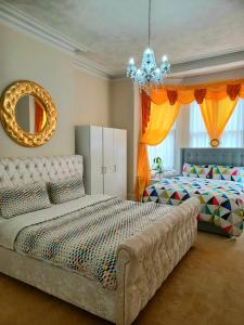 a bedroom with a large bed and a mirror at Gabriel Guesthouse in Rhyl