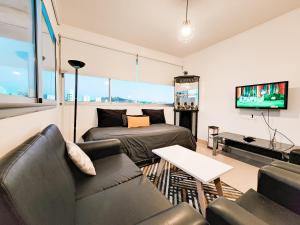 a living room with a couch and a table at Altos de Tandil II centro con cochera y parrilla in Tandil