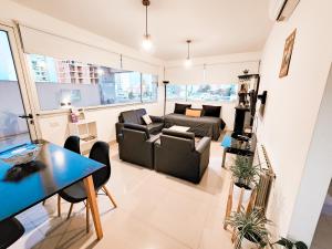a living room with a couch and a table at Altos de Tandil II centro con cochera y parrilla in Tandil