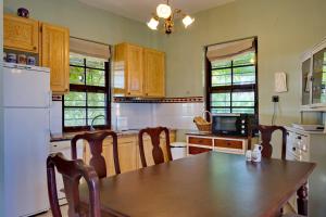 a kitchen with a wooden table and a refrigerator at Vintage country house in Halkidiki in Nea Fokea +45 photos