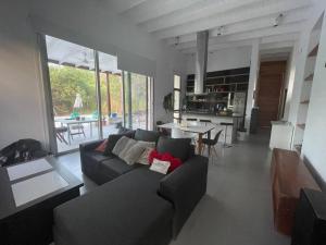 a living room with a couch and a table at Casa con Piscina y Mirador privado en San Marcos Sierras in San Marcos Sierras