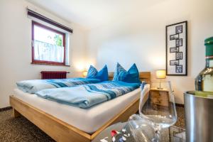 a bedroom with a bed with blue pillows on it at Appartement Weitsicht in Eben im Pongau
