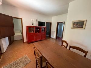 a living room with a wooden table and a red cabinet at Villino Panorama in Putignano