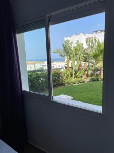 a window in a room with a view of the ocean at Tamuda Bay- Alcudia Smir - Fnideq in Fnidek