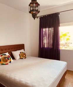 a bedroom with a bed and a window at Tamuda Bay- Alcudia Smir - Fnideq in Fnidek