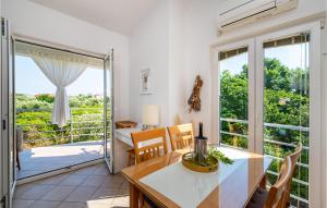 a kitchen and dining room with a table and chairs at Pet Friendly Home In Bibinje With Kitchen in Bibinje