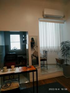 a living room with a table and a window at Lavalle Studio Buenos Aires in Buenos Aires