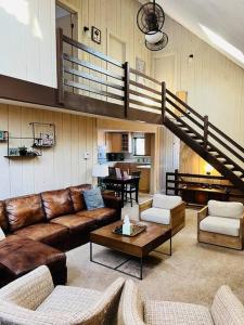 a large living room with couches and a staircase at MT SNOW SKI-BACK TRAIL FREE SHUTTLE - Green Mountain House in Dover