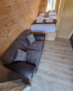 a living room with two beds and a couch at Caledonian Pod. In Caol, Fort William in Caol