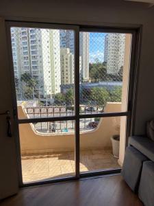 an open door to a balcony with a view of a city at Apartamento Giovanni Gronchi in Sao Paulo