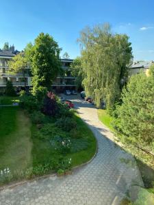 a walkway in a park with flowers and trees at Apartament przy Parku Czartoryskich in Puławy