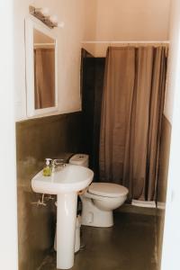 a bathroom with a sink and a toilet and a mirror at Hostal Africa in Tarifa +71 photos